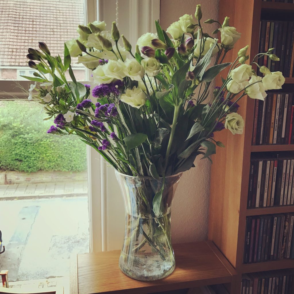 white and purple Freddie's flowers in vase